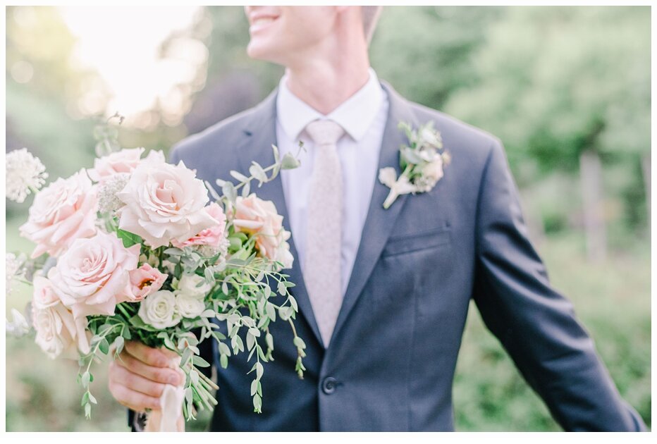 groom holding bride's bouquet