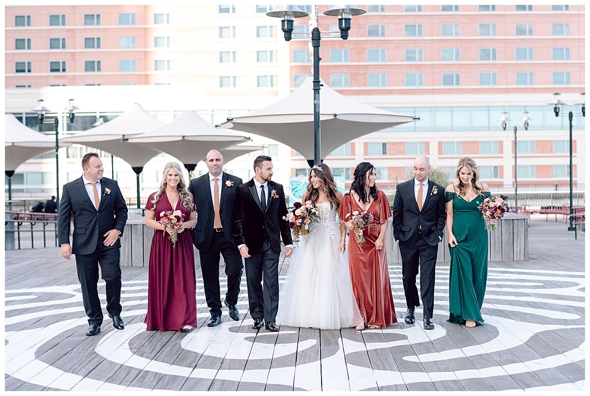 bridal party walking on pier and talking