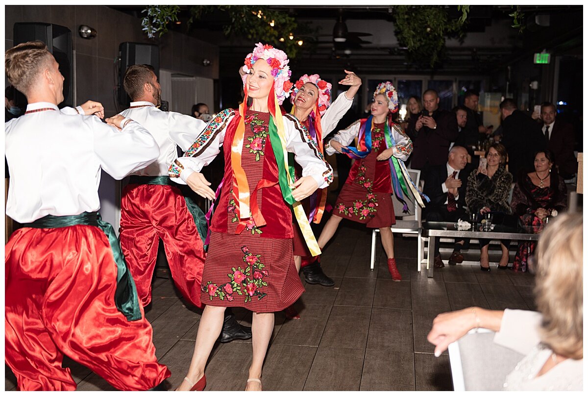 russian dancers with colorful costumes dancing at a wedding