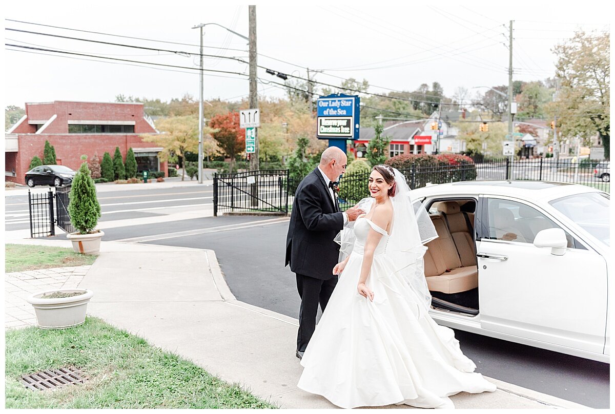 bride and dad getting out of limo at church for wedding ceremony