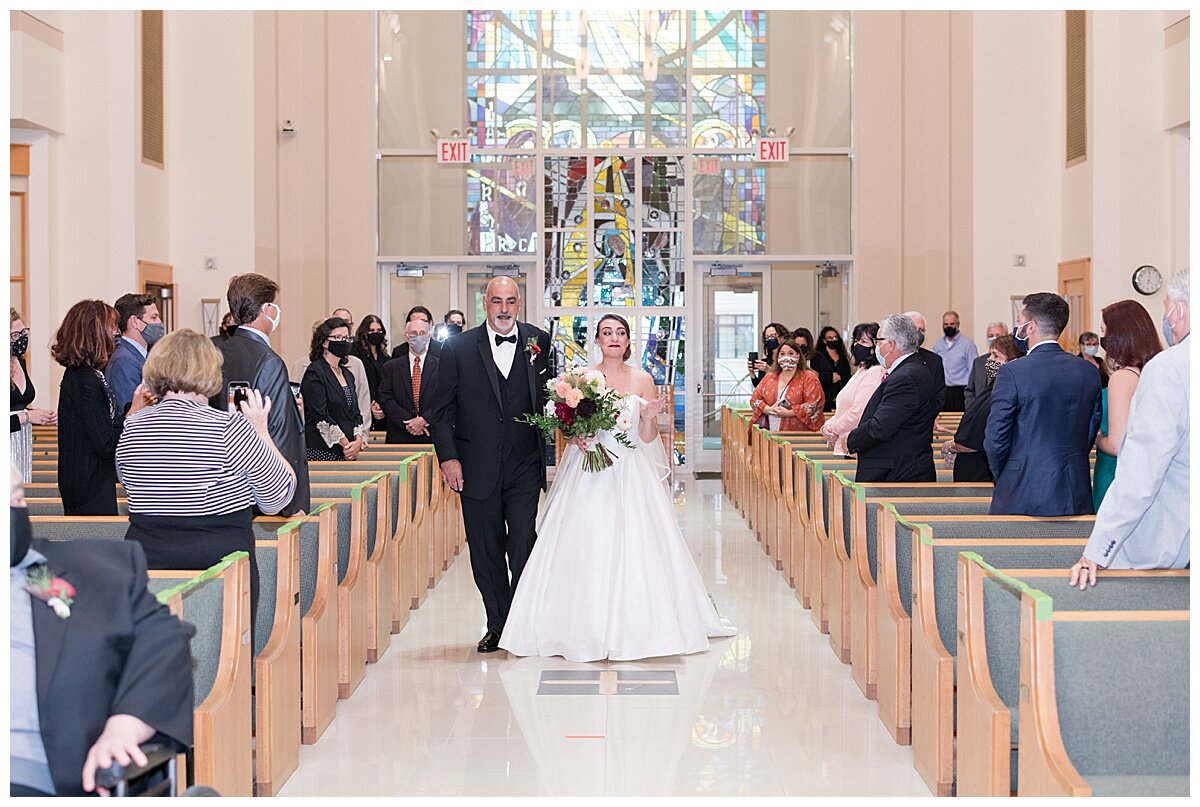 father walking daughter down the aisle at church