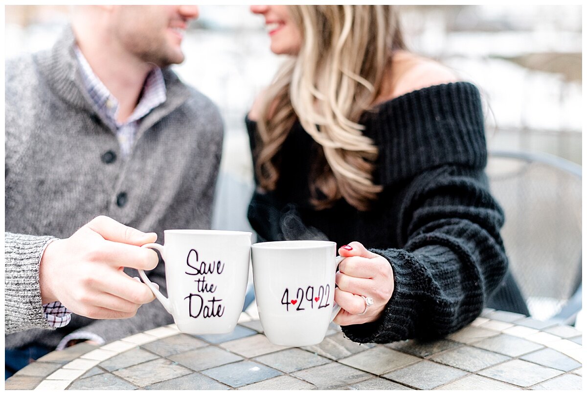 engaged couple holding coffee mugs with wedding date printed on it