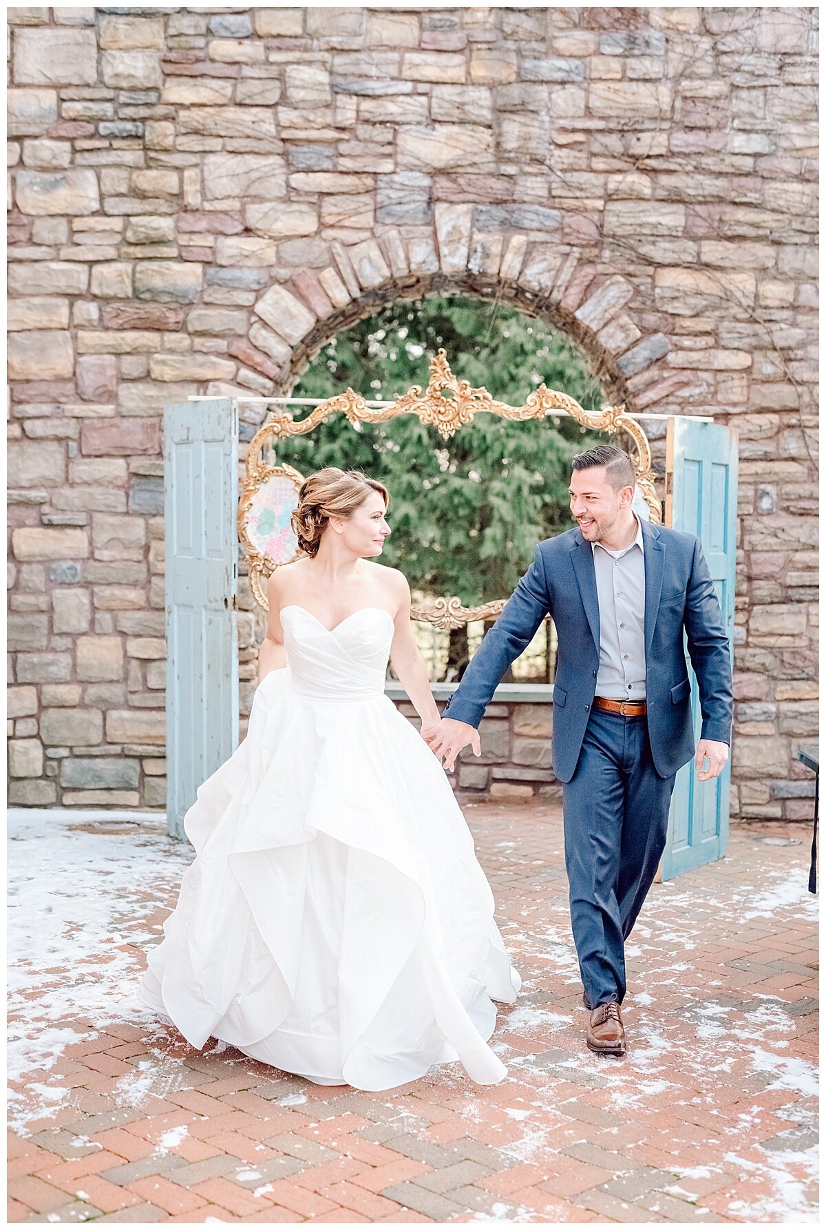 bride and groom walking and smiling at each other