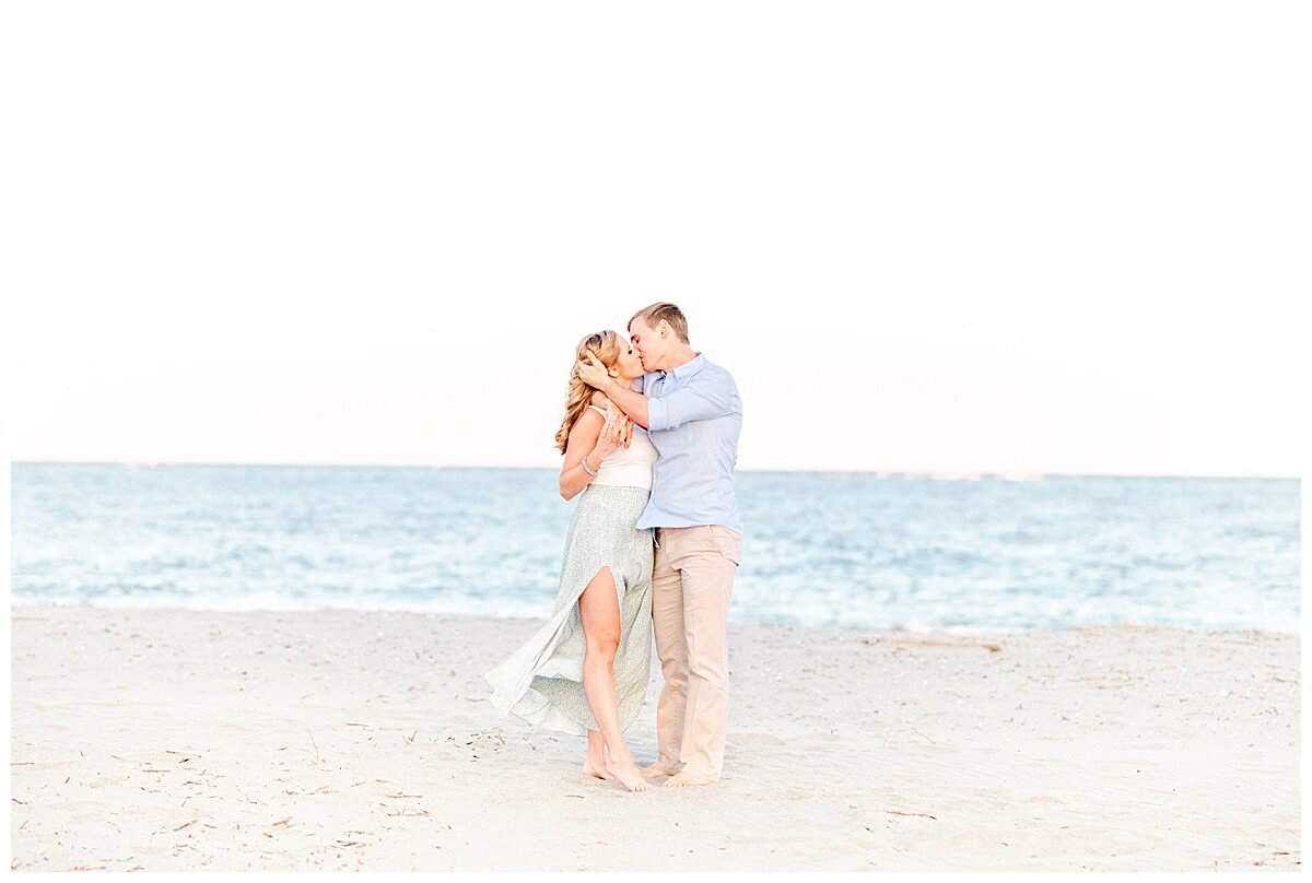 engagement session couple kissing on beach