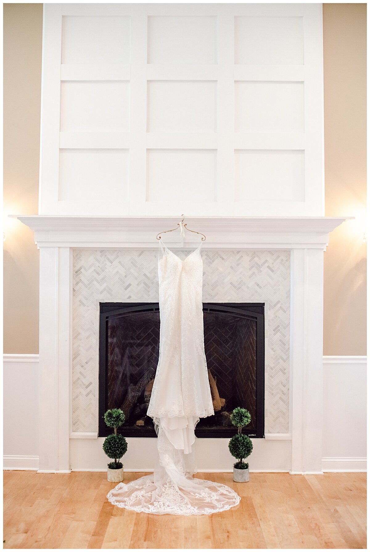 wedding gown hanging on a white fireplace