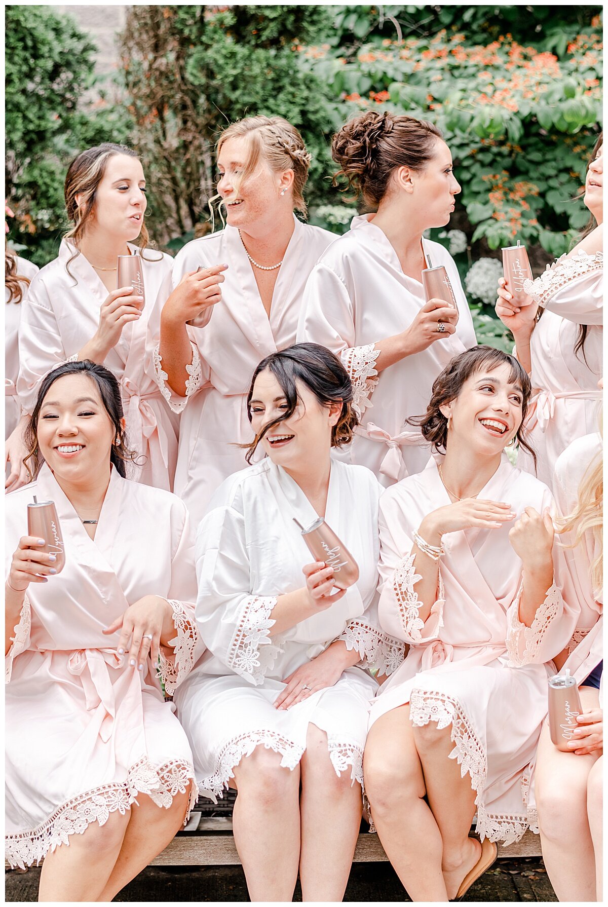 bride and bridesmaids toasting in pretty pink robes