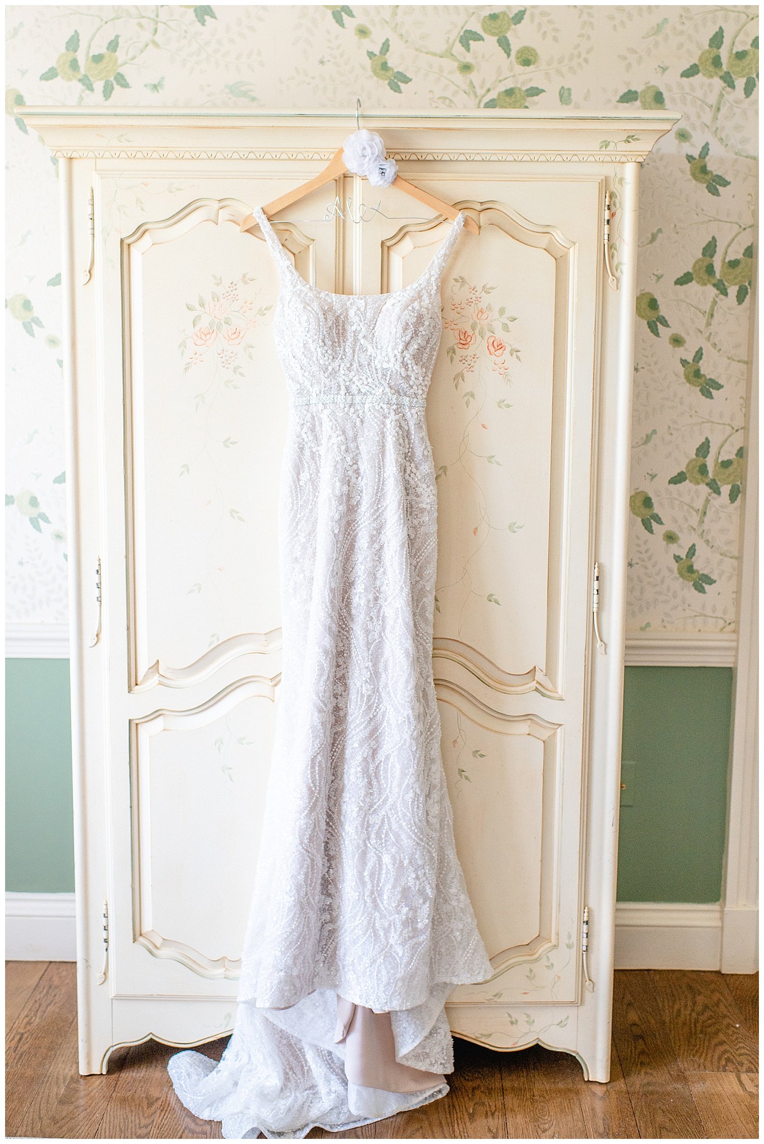 wedding gown hanging on an armoire