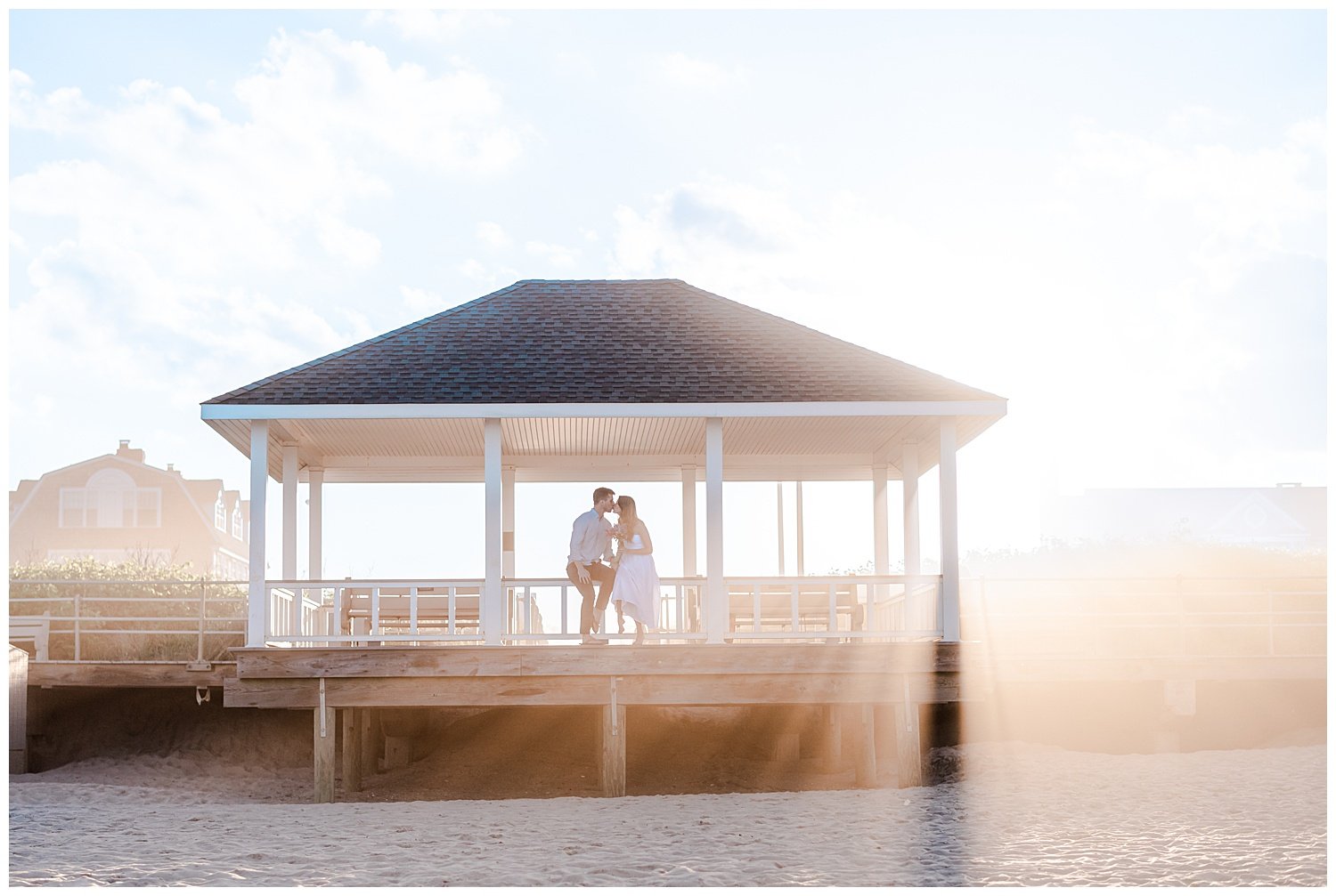 couple in a gazebo on the beach at sunset