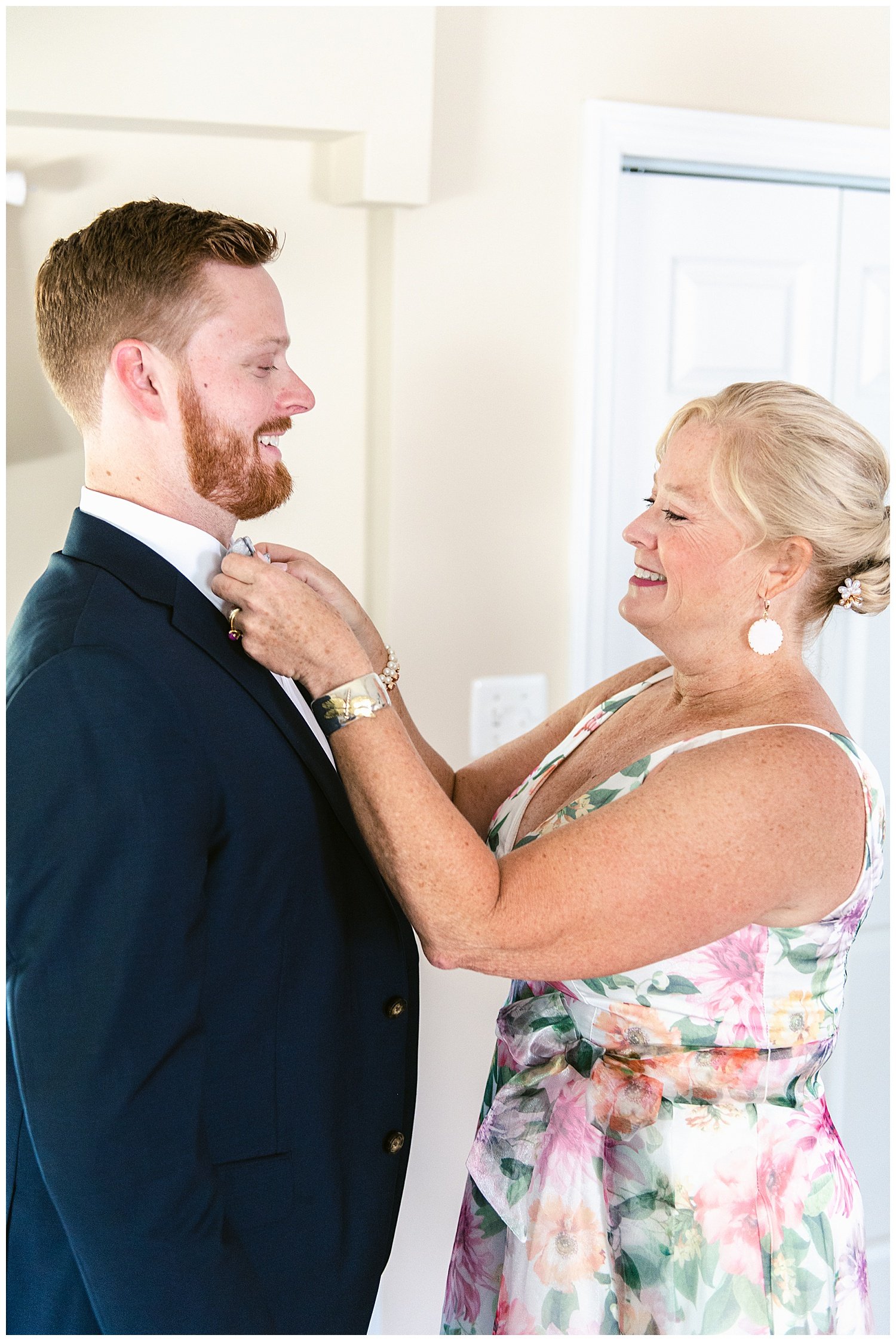 mother of the groom putting his bow tie on
