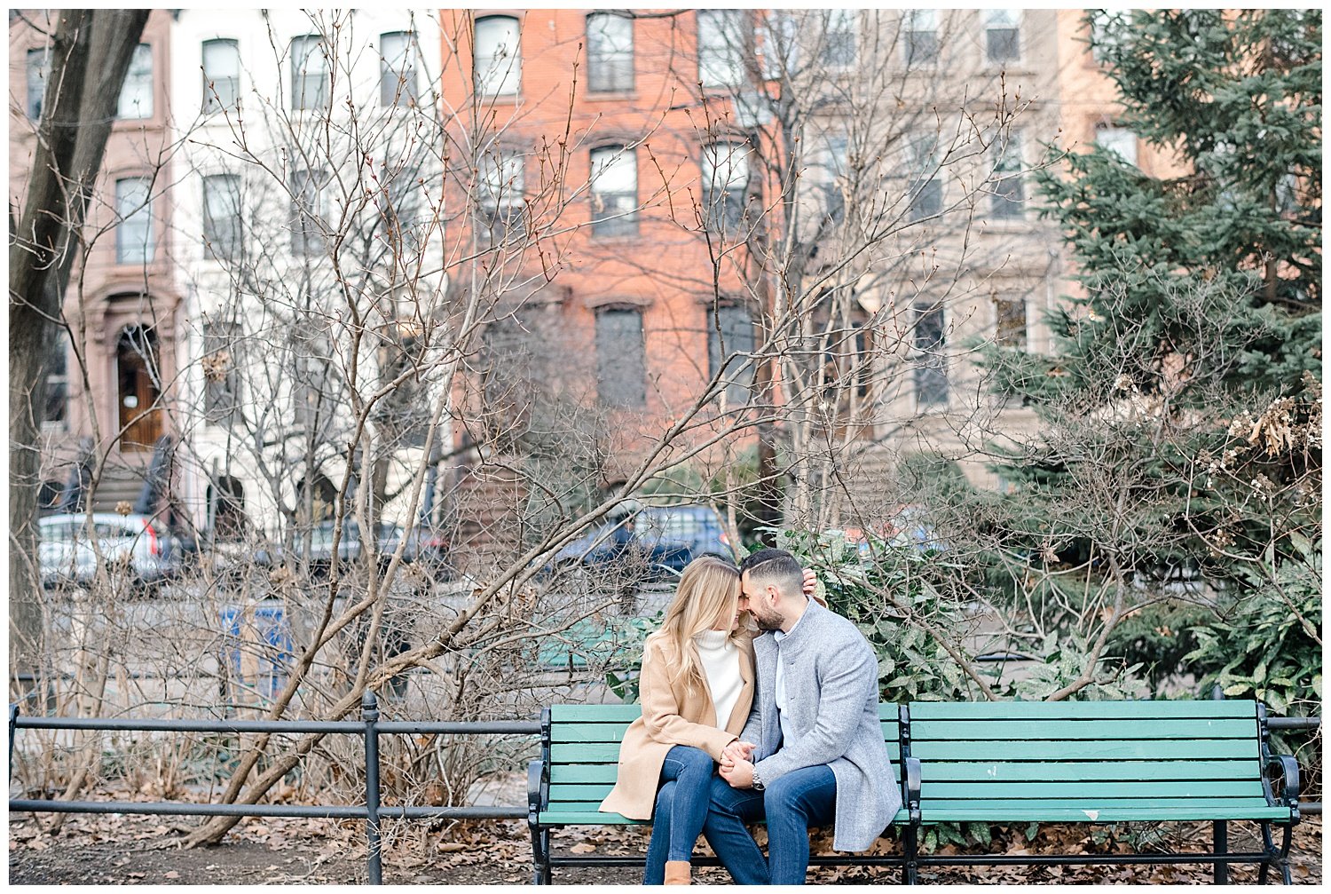 engaged couple sitting on a park bench