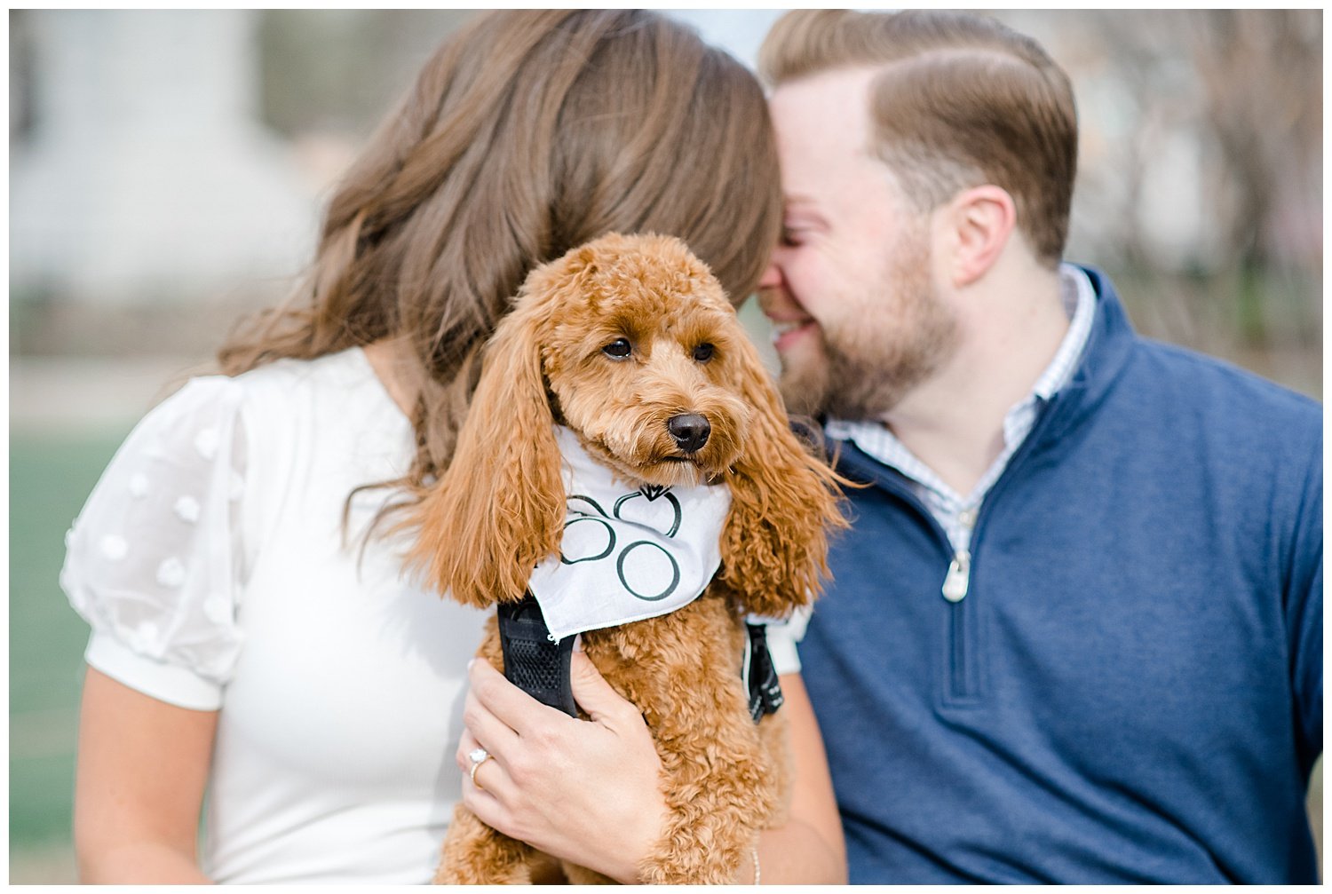 engaged couple posing with their dog