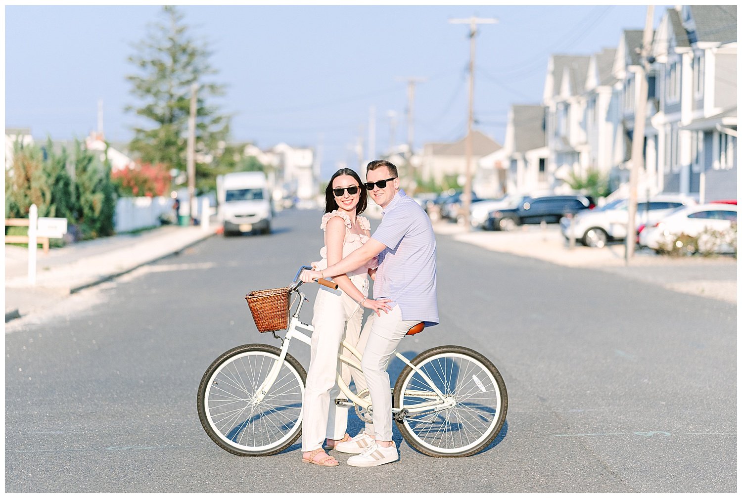 engaged couple at the beach on a bicycle