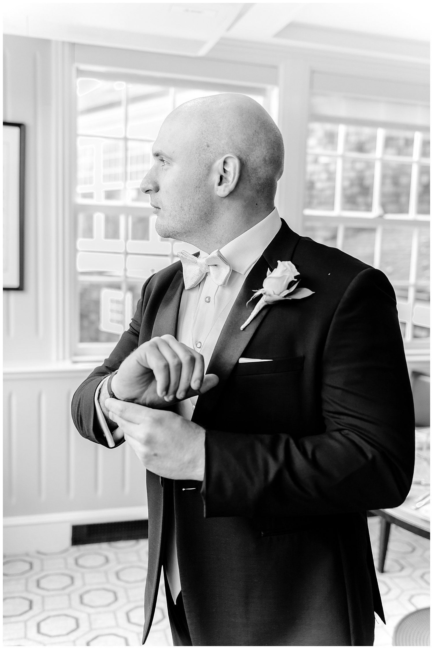 groom getting ready putting on cufflinks