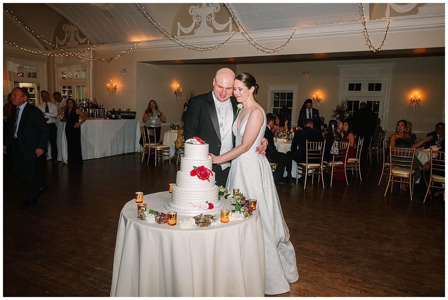 bride and groom cutting wedding cake