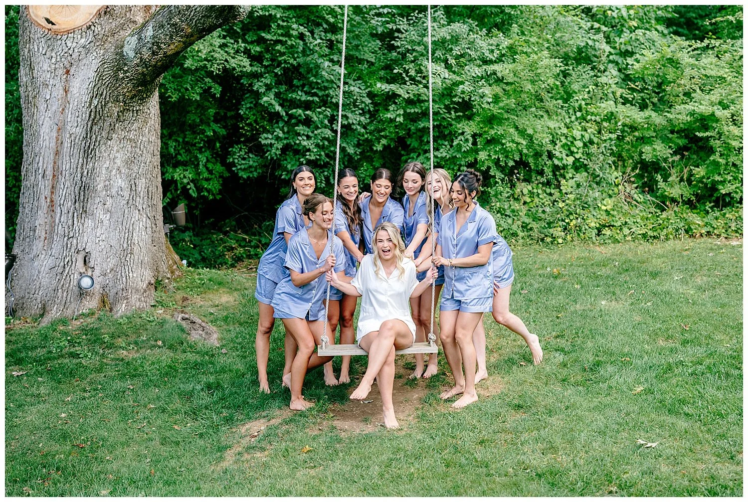 bride and bridesmaid on a pretty swing at crossed keys estate