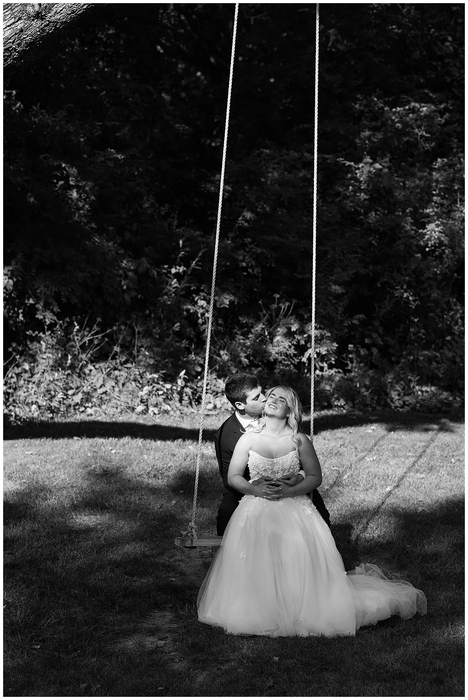 portrait of bride and groom on a swing