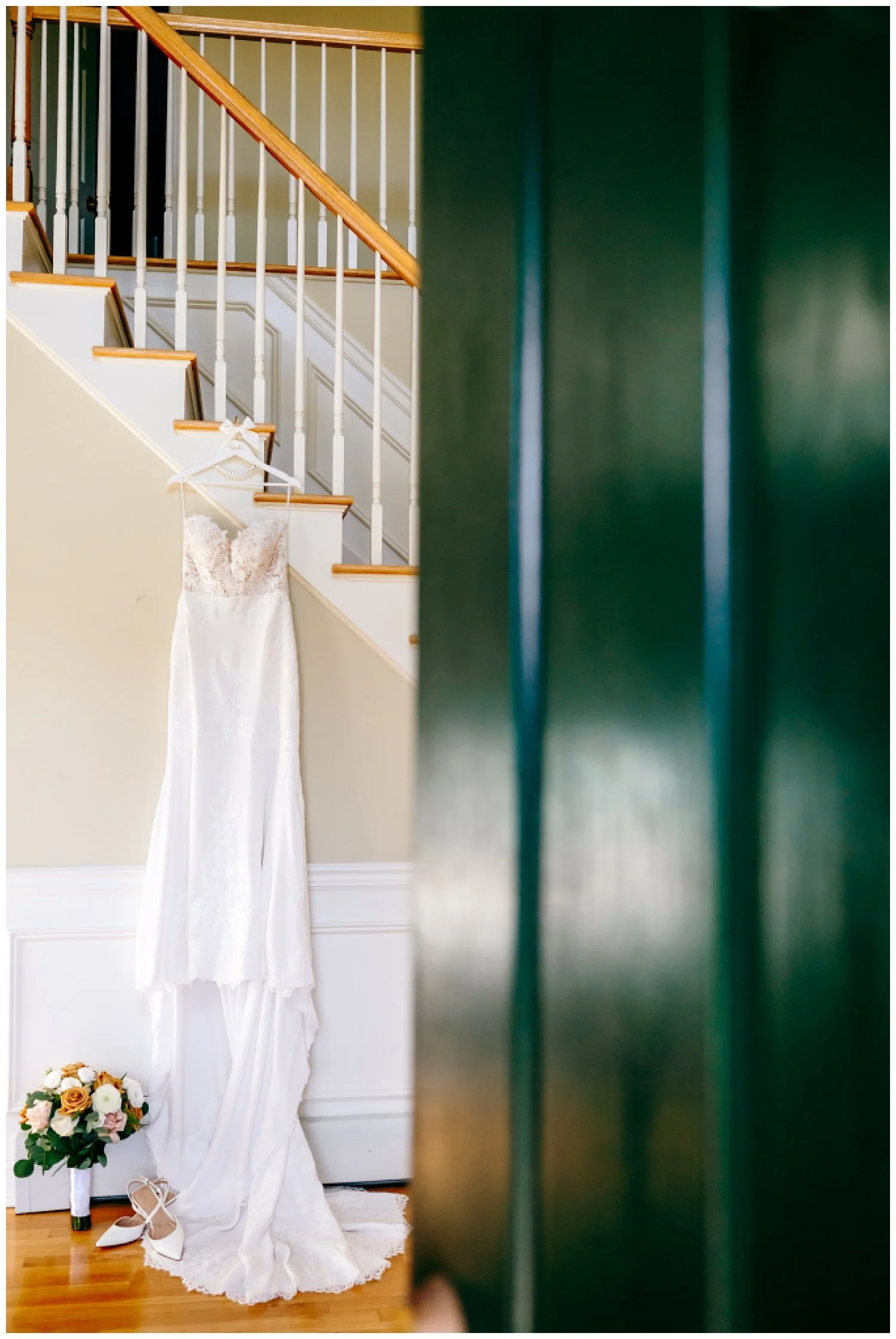 a wedding gown hanging in the hallway