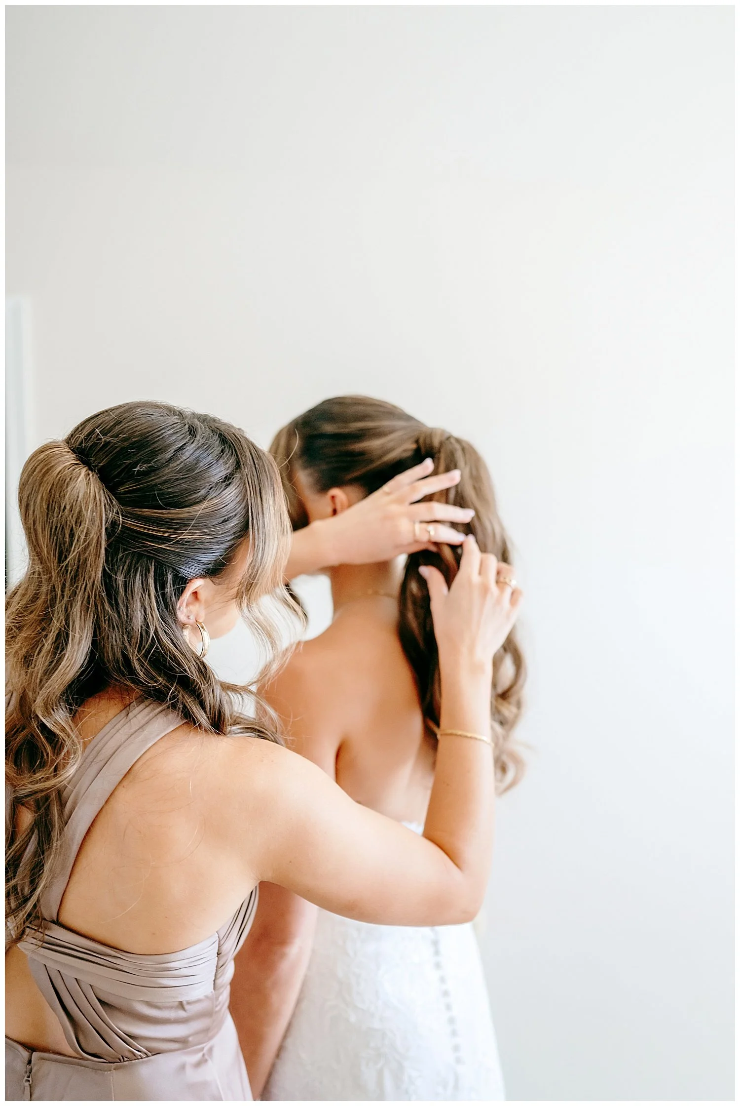 sister fixing brides hair