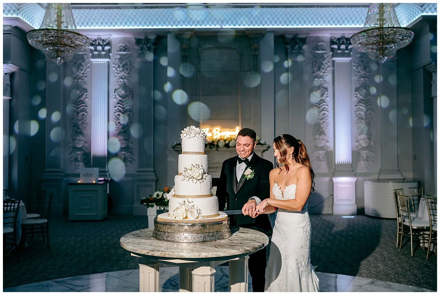 bride and groom cutting wedding cake