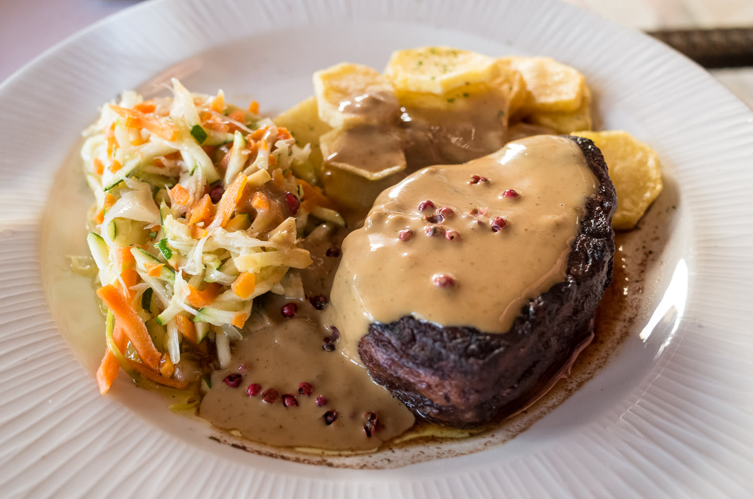 Grilled fillet steak with peppered sauce and sauté potatos