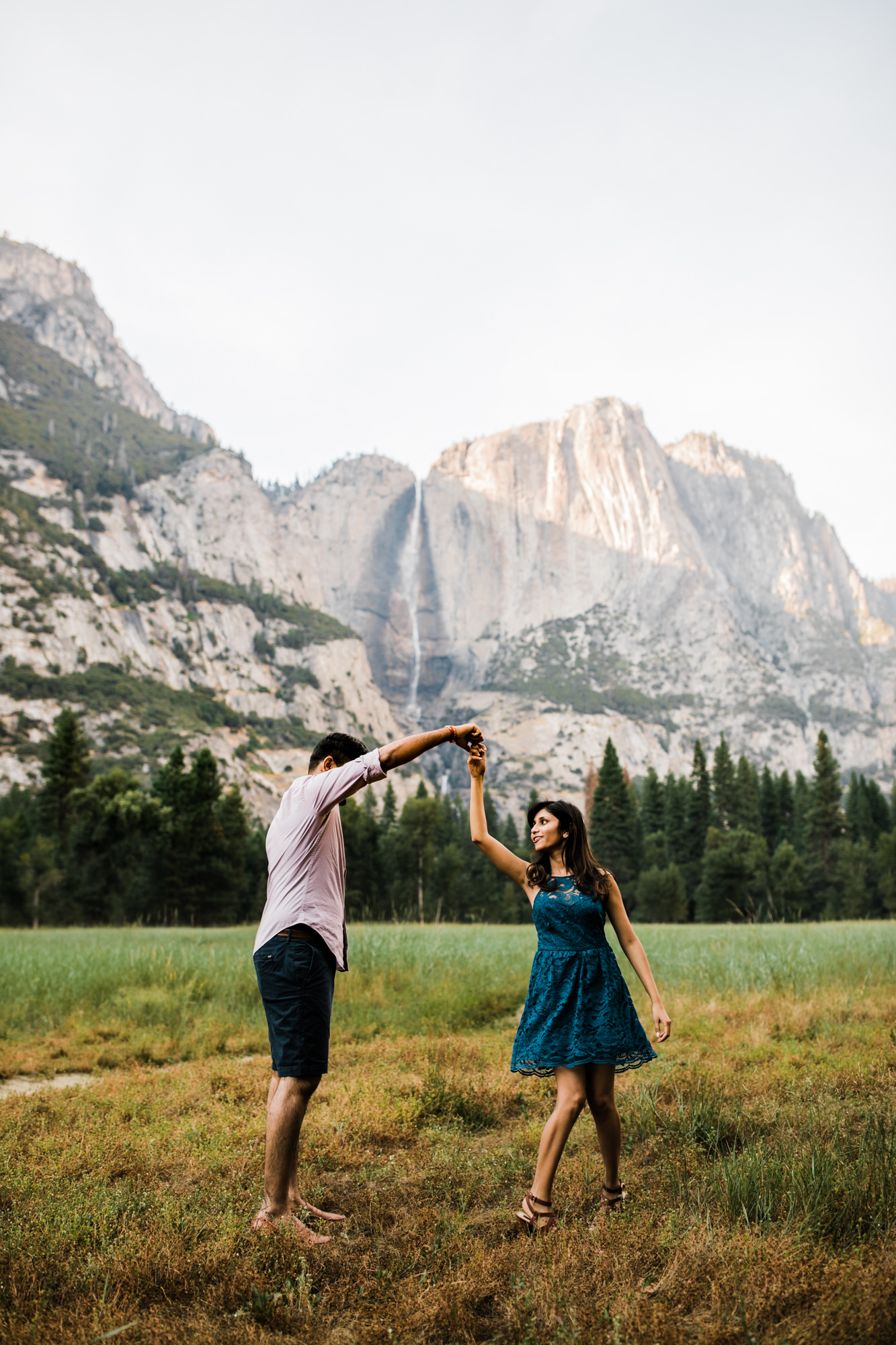 dreema + jay's adventurous engagement session + surprise proposal | yosemite valley + glacier point, yosemite national park | destination elopement photographer | www.thehearnes.com