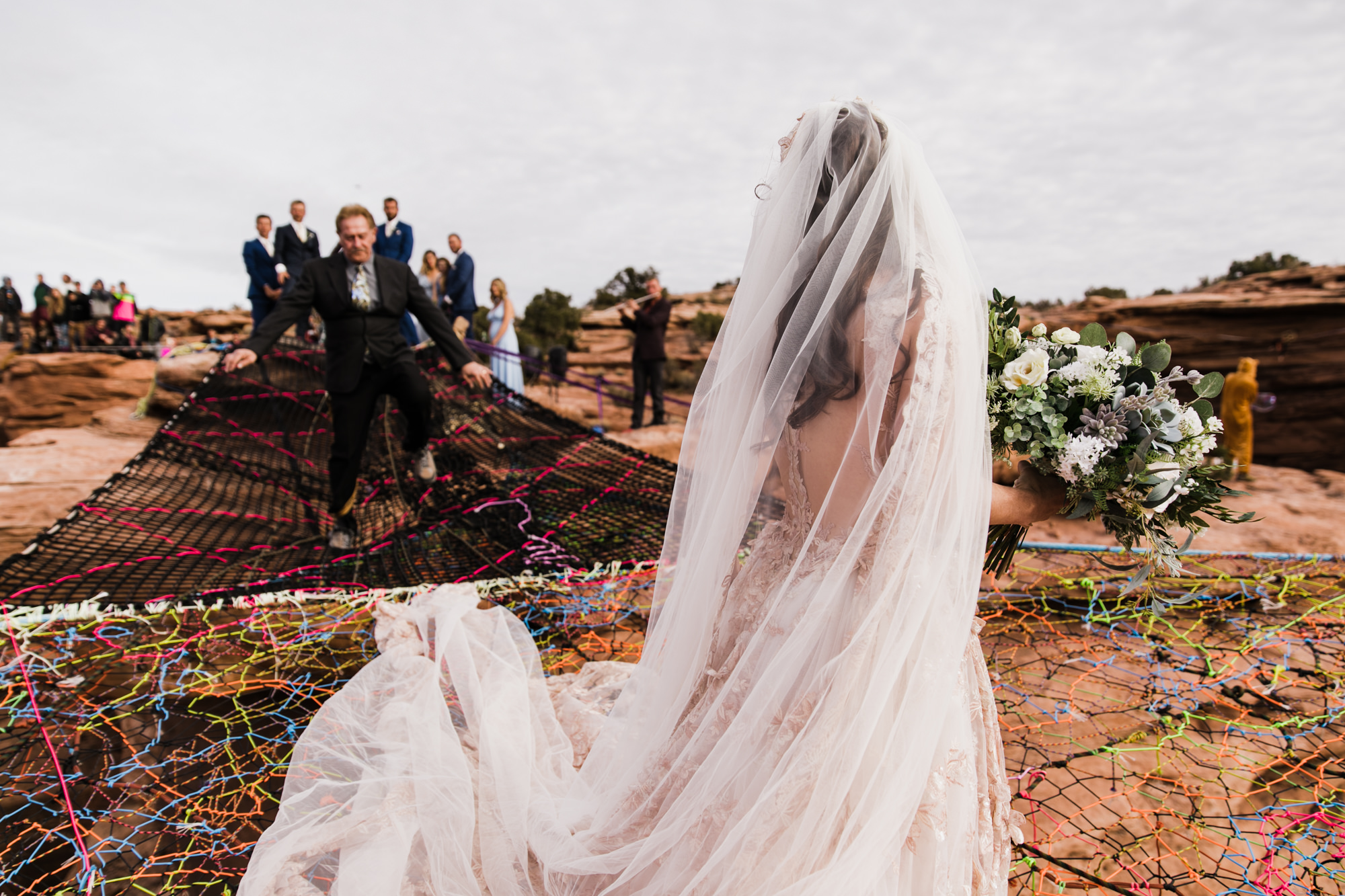 spacenet wedding 400 feet above a canyon in moab, utah | adventurous desert elopement | galia lahav bride | the hearnes adventure wedding photography | www.thehearnes.com