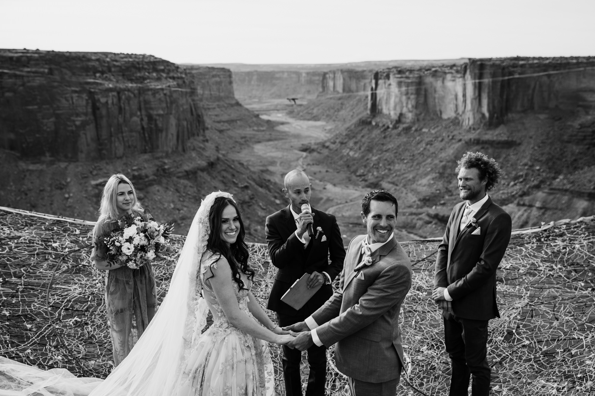 spacenet wedding 400 feet above a canyon in moab, utah | adventurous desert elopement | galia lahav bride | the hearnes adventure wedding photography | www.thehearnes.com