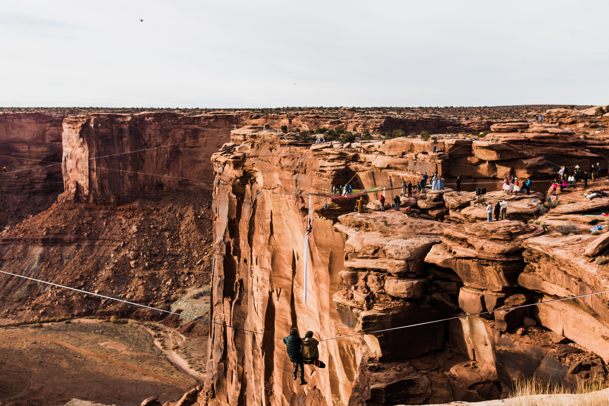 spacenet wedding 400 feet above a canyon in moab, utah | adventurous desert elopement | galia lahav bride | the hearnes adventure wedding photography | www.thehearnes.com