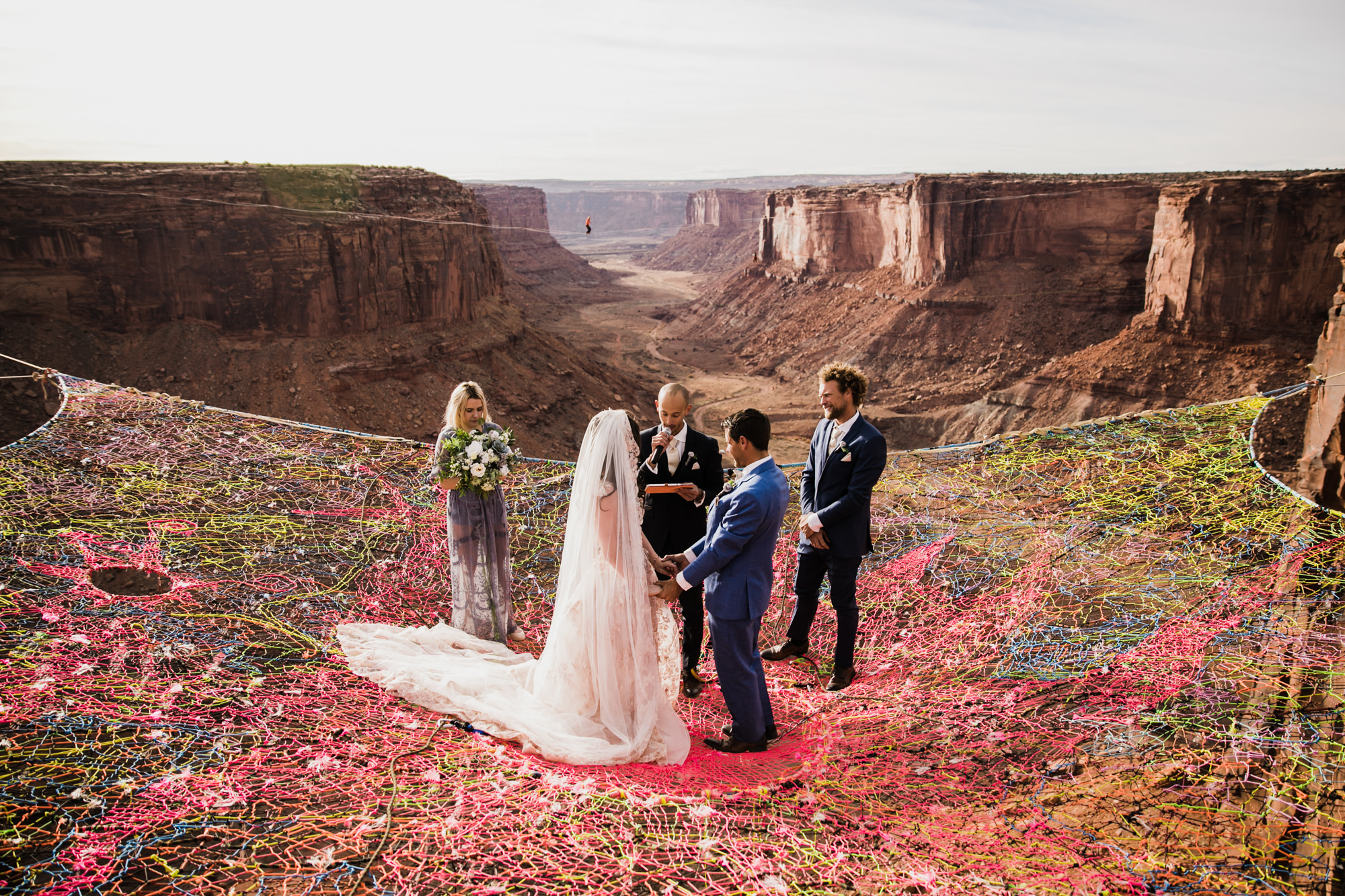 spacenet wedding 400 feet above a canyon in moab, utah | adventurous desert elopement | galia lahav bride | the hearnes adventure wedding photography | www.thehearnes.com