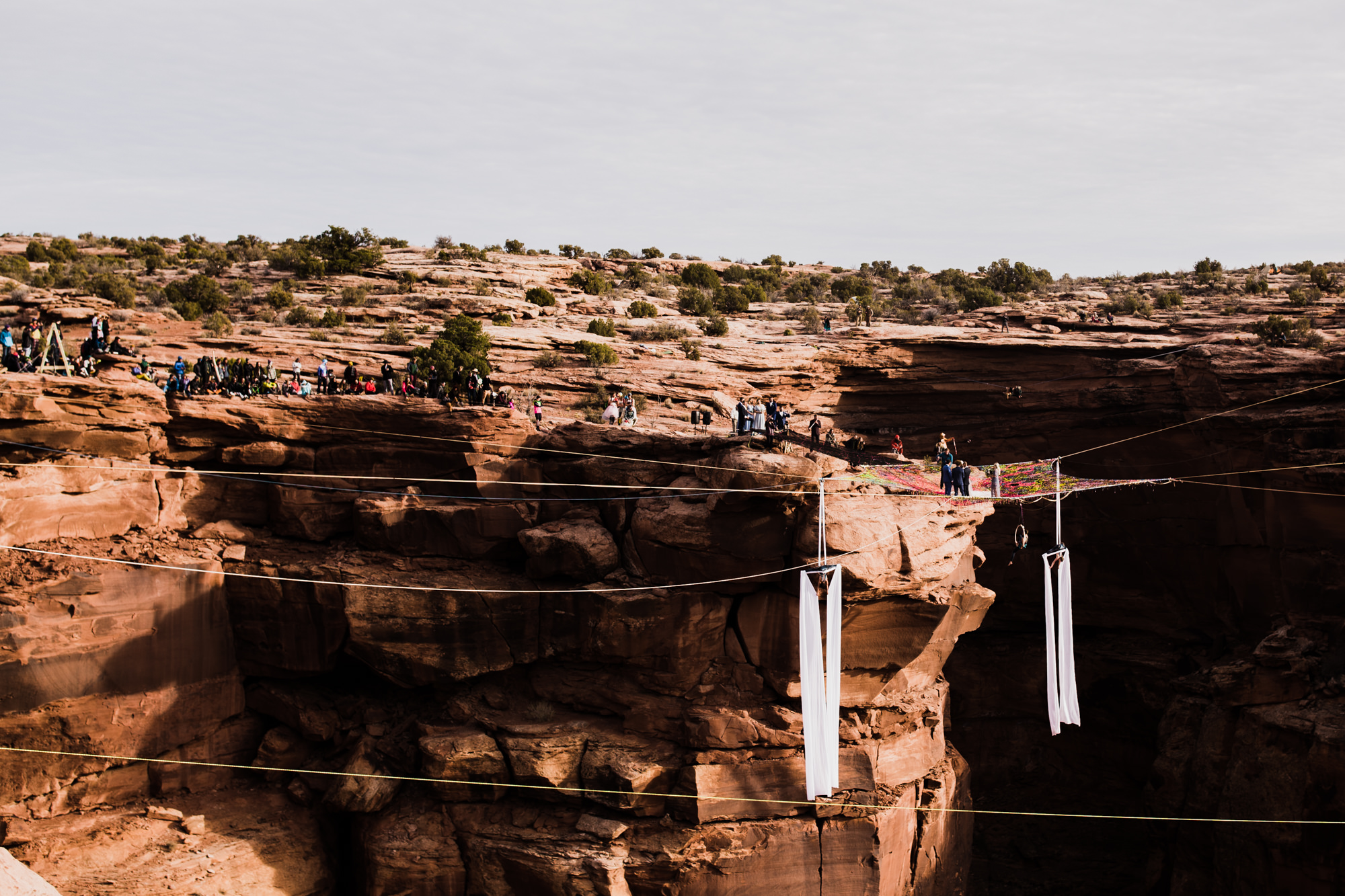 spacenet wedding 400 feet above a canyon in moab, utah | adventurous desert elopement | galia lahav bride | the hearnes adventure wedding photography | www.thehearnes.com