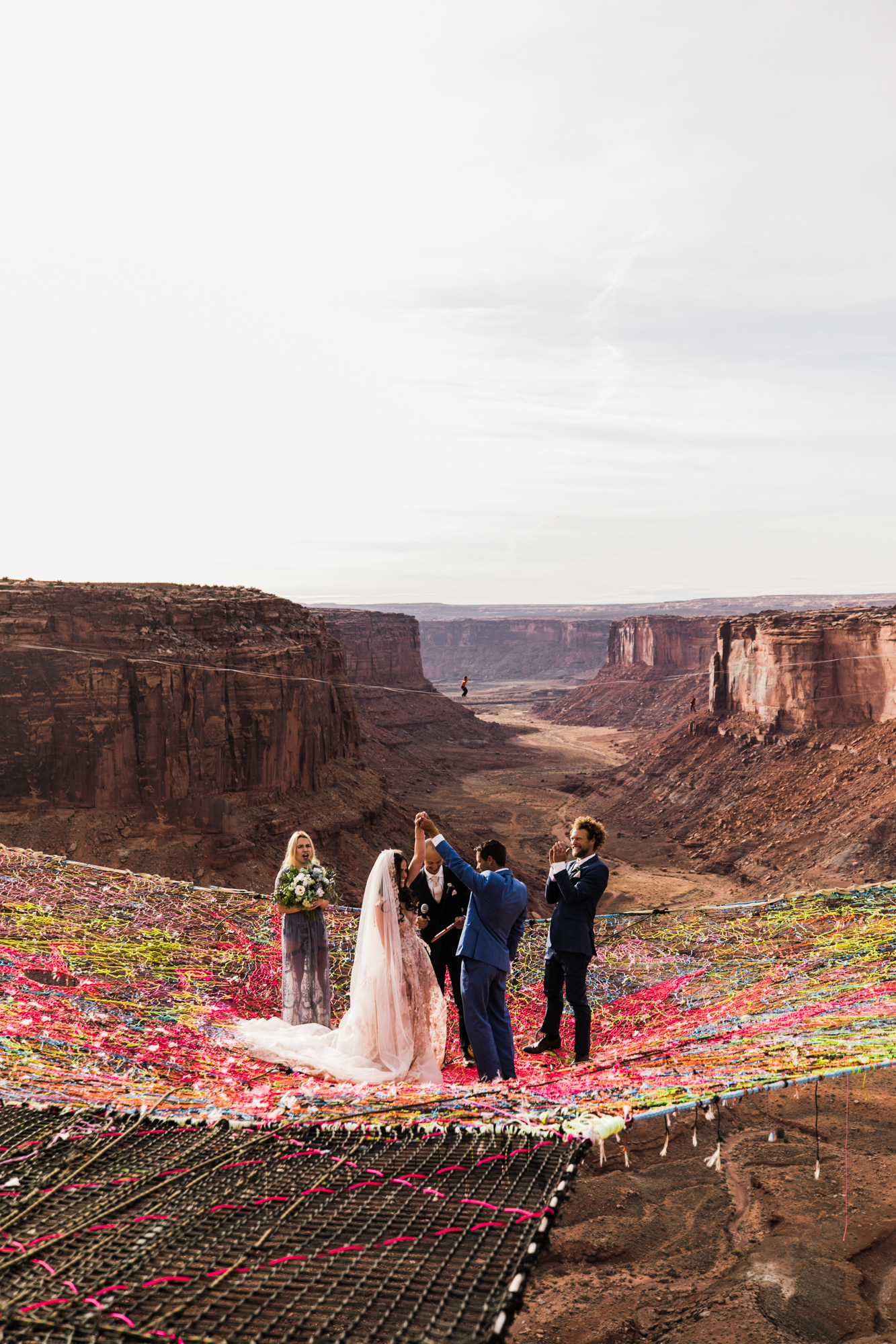 spacenet wedding 400 feet above a canyon in moab, utah | adventurous desert elopement | galia lahav bride | the hearnes adventure wedding photography | www.thehearnes.com