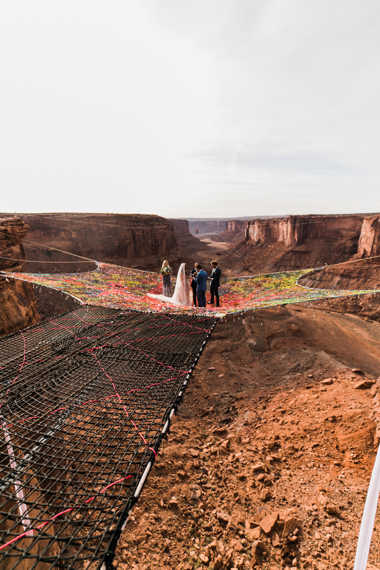 spacenet wedding 400 feet above a canyon in moab, utah | adventurous desert elopement | galia lahav bride | the hearnes adventure wedding photography | www.thehearnes.com