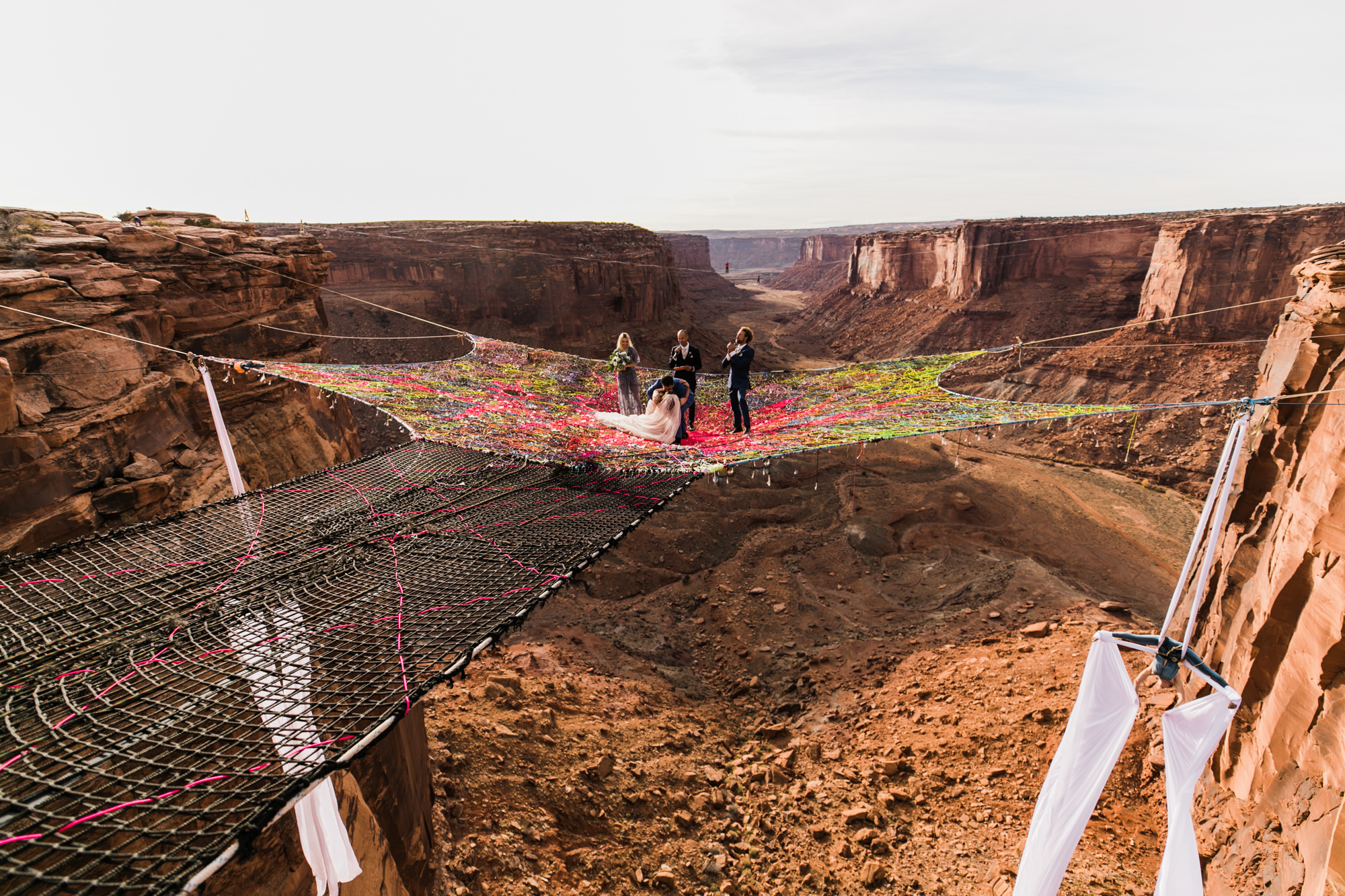 spacenet wedding 400 feet above a canyon in moab, utah | adventurous desert elopement | galia lahav bride | the hearnes adventure wedding photography | www.thehearnes.com