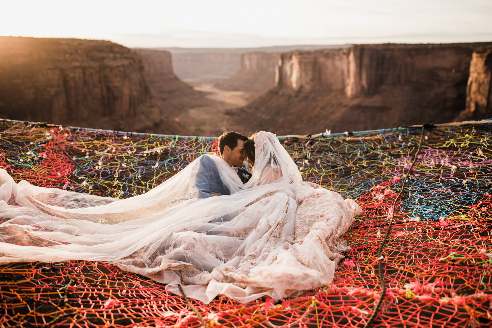 spacenet wedding 400 feet above a canyon in moab, utah | adventurous desert elopement | galia lahav bride | the hearnes adventure wedding photography | www.thehearnes.com