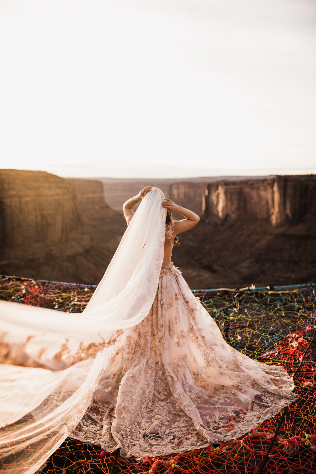 spacenet wedding 400 feet above a canyon in moab, utah | adventurous desert elopement | galia lahav bride | the hearnes adventure wedding photography | www.thehearnes.com