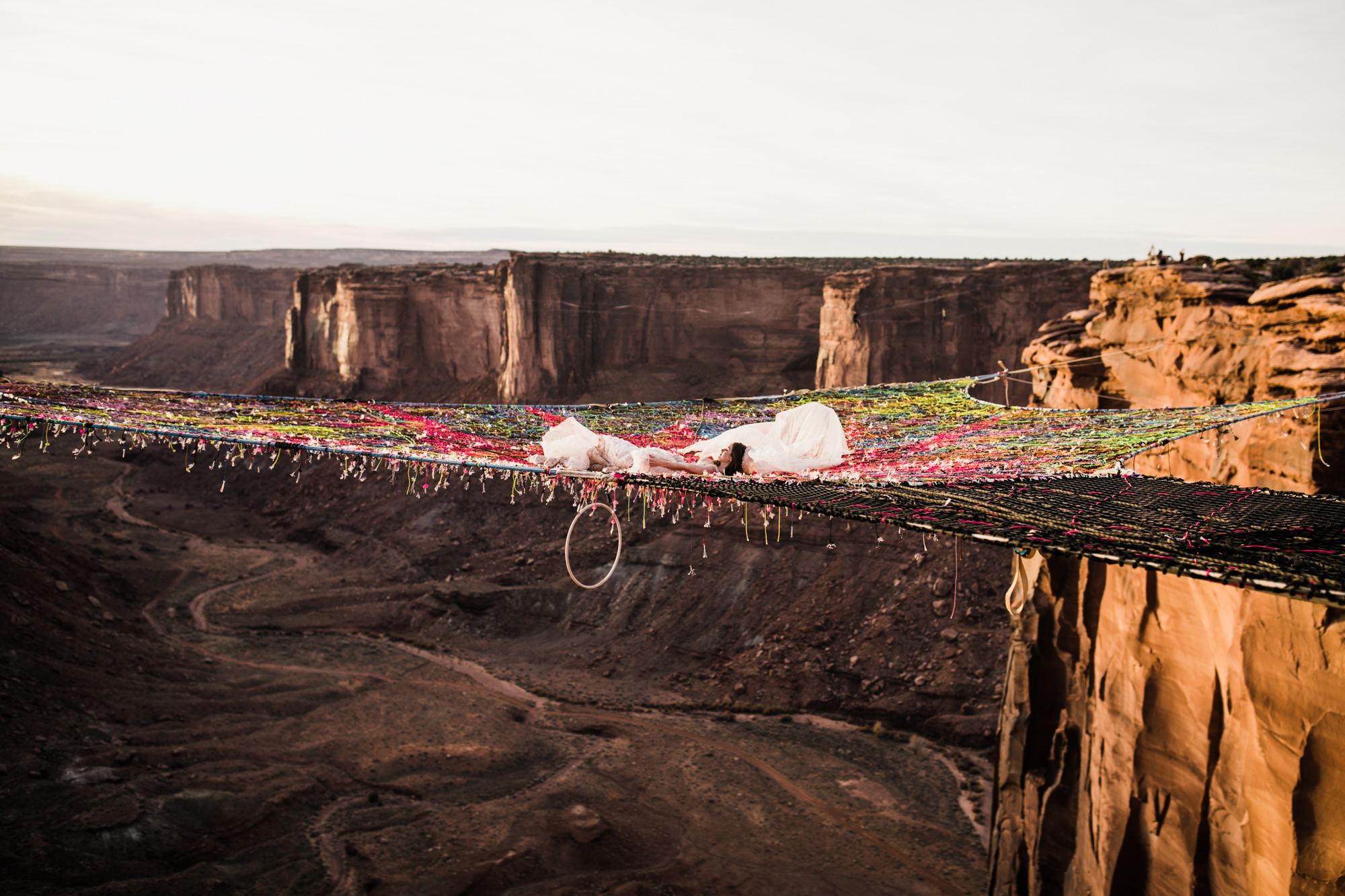 spacenet wedding 400 feet above a canyon in moab, utah | adventurous desert elopement | galia lahav bride | the hearnes adventure wedding photography | www.thehearnes.com