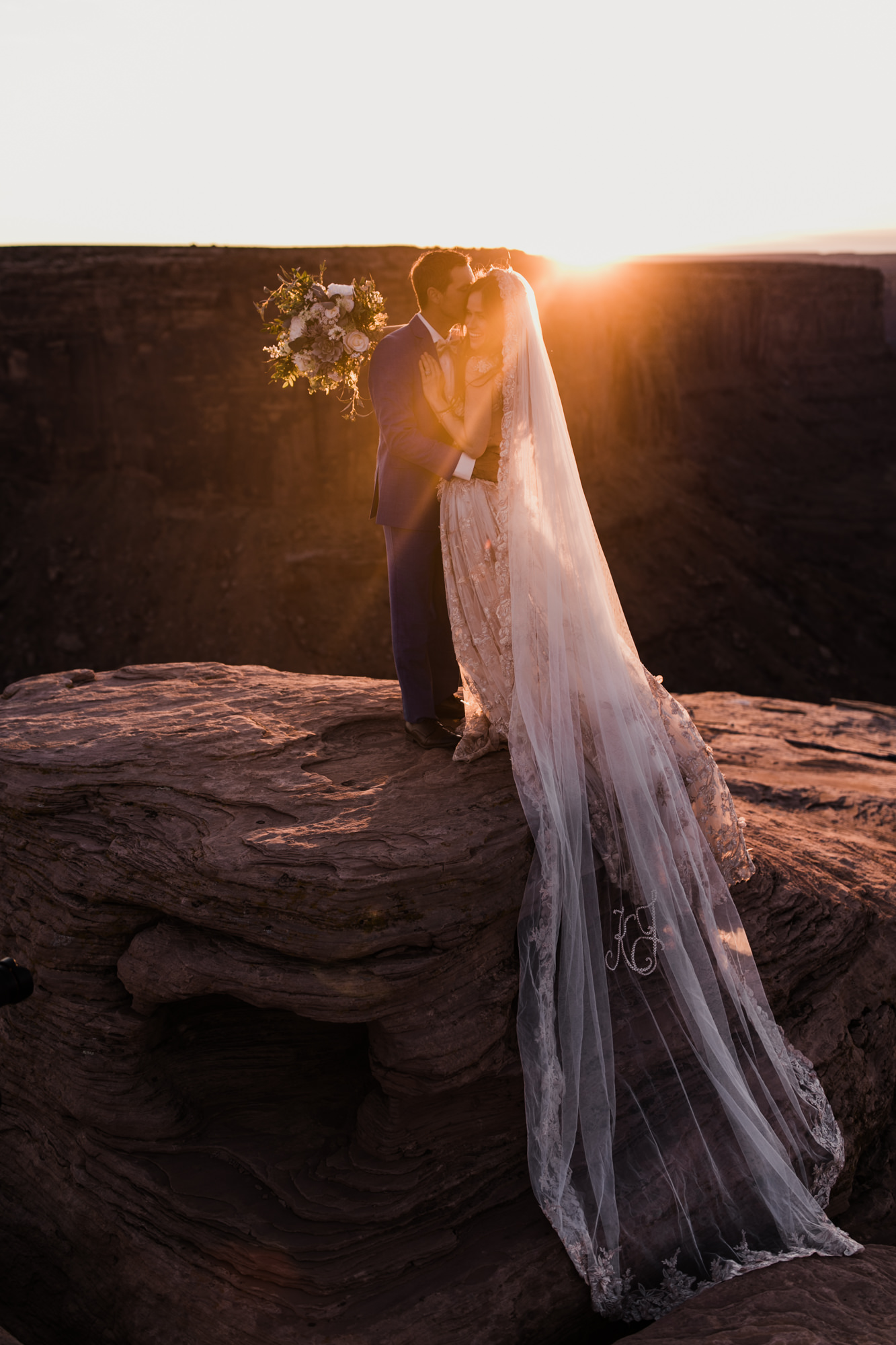 spacenet wedding 400 feet above a canyon in moab, utah | adventurous desert elopement | galia lahav bride | the hearnes adventure wedding photography | www.thehearnes.com