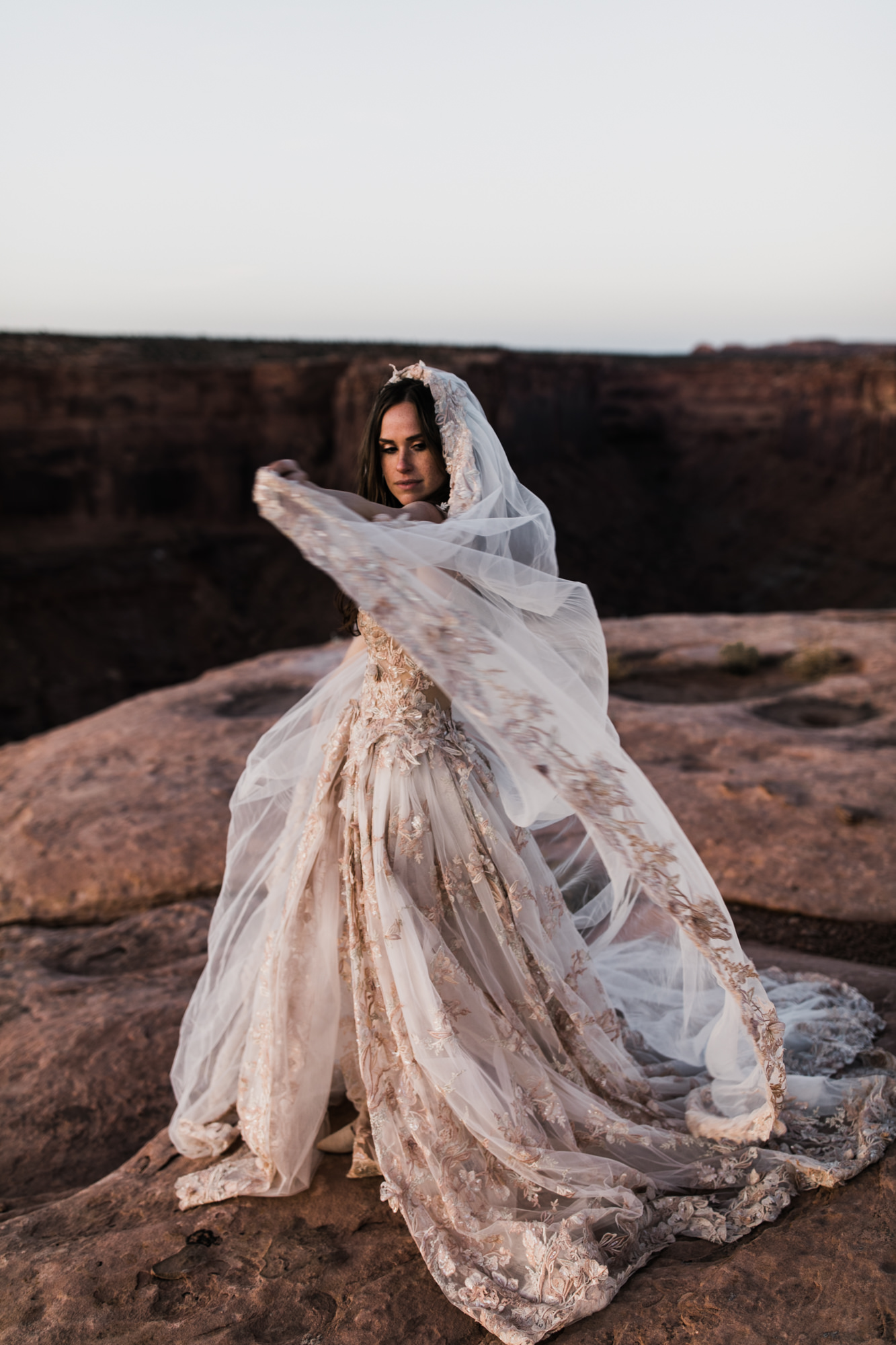 spacenet wedding 400 feet above a canyon in moab, utah | adventurous desert elopement | galia lahav bride | the hearnes adventure wedding photography | www.thehearnes.com