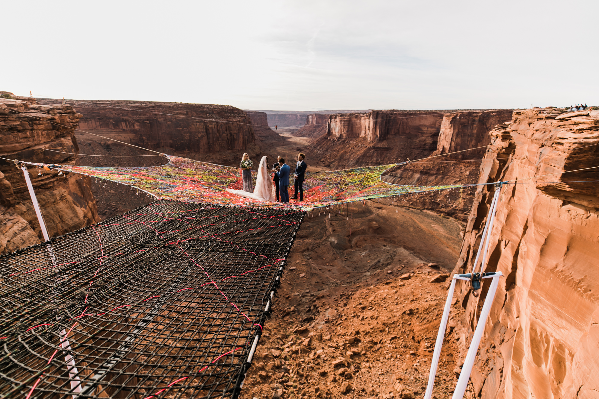 spacenet wedding 400 feet above a canyon in moab, utah | adventurous desert elopement | galia lahav bride | the hearnes adventure wedding photography | www.thehearnes.com