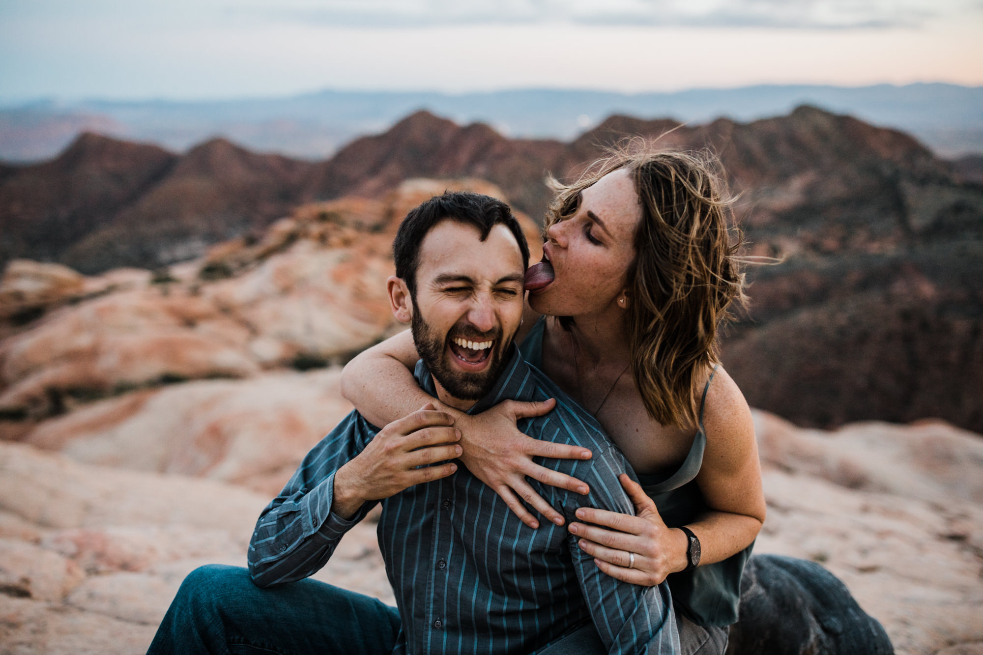 windy adventure engagement session in the utah desert | destination engagement photo inspiration | utah adventure elopement photographers | the hearnes adventure photography | www.thehearnes.com