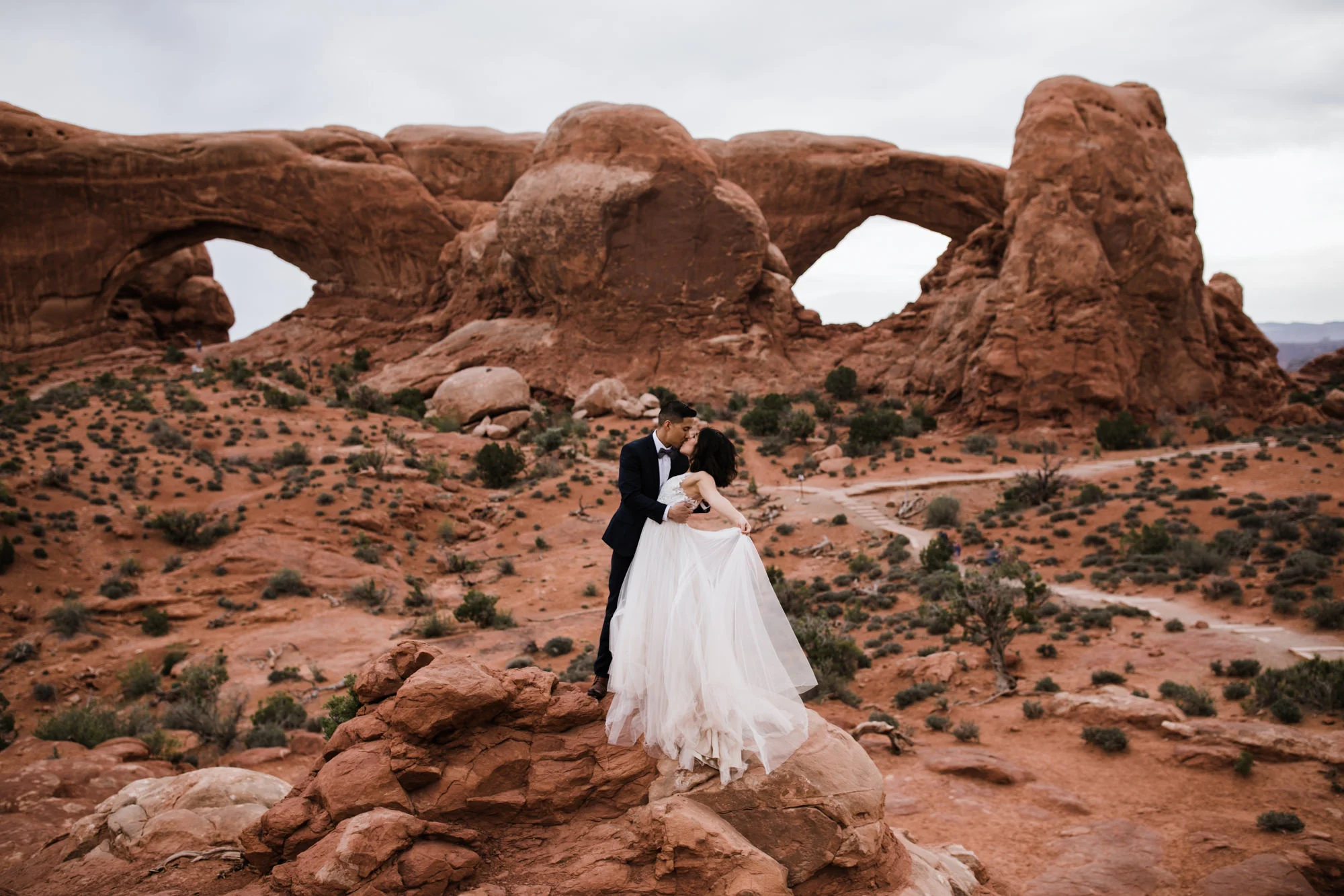elopement first look in arches national park | desert elopement | moab wedding photographer | the hearnes adventure photography | www.thehearnes.com