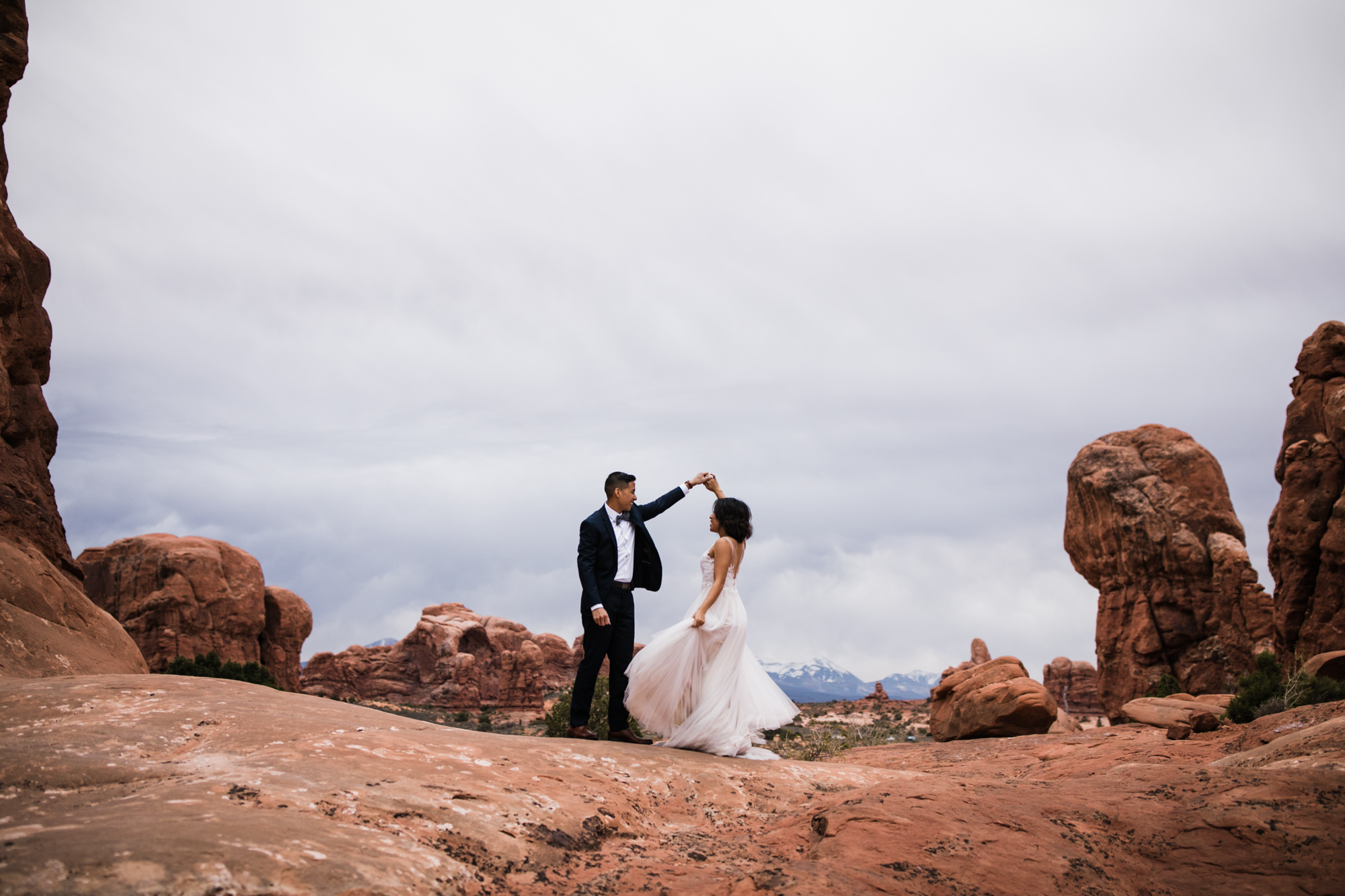 elopement first look in arches national park | desert elopement | moab wedding photographer | the hearnes adventure photography | www.thehearnes.com