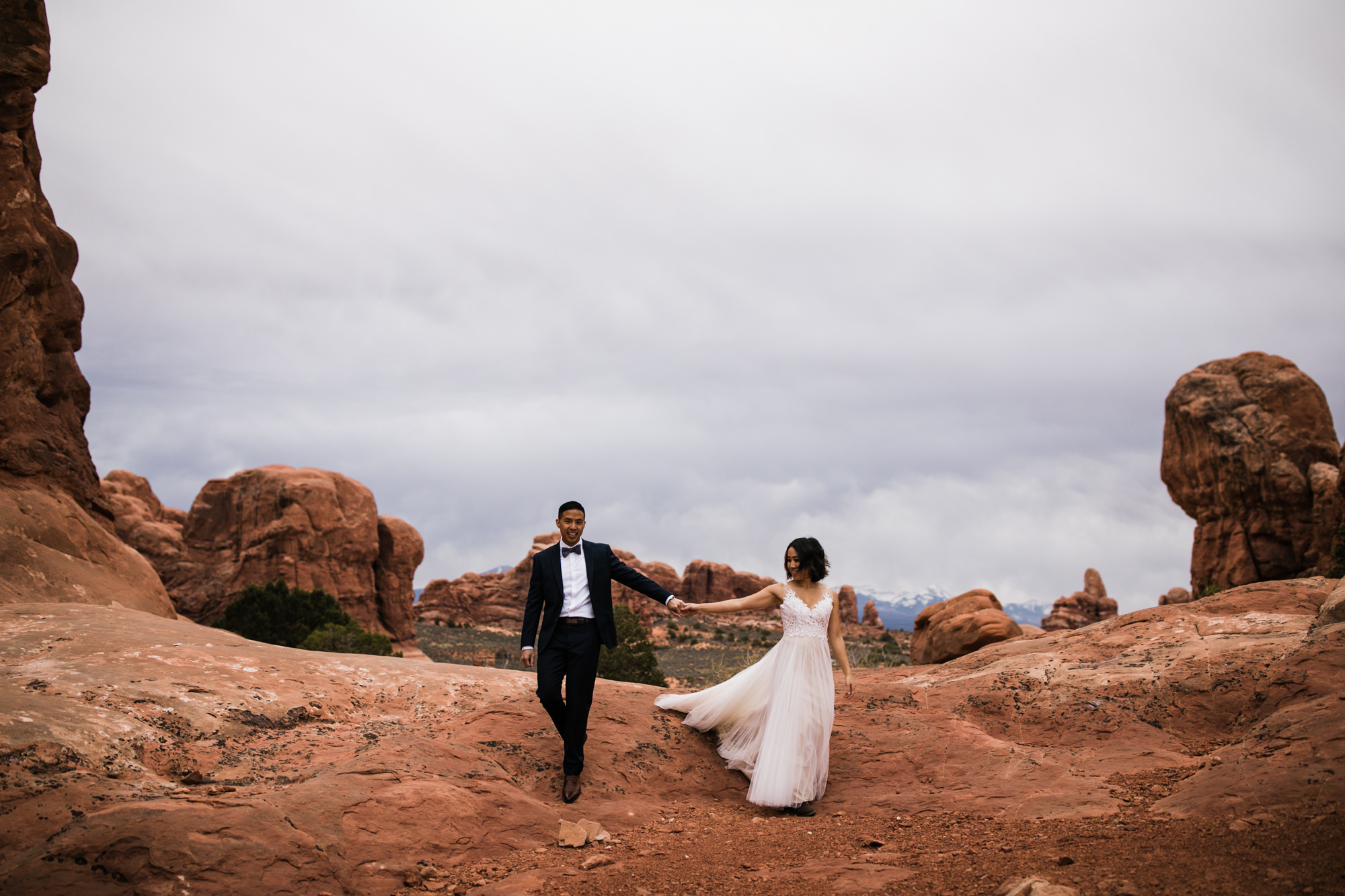 elopement first look in arches national park | desert elopement | moab wedding photographer | the hearnes adventure photography | www.thehearnes.com