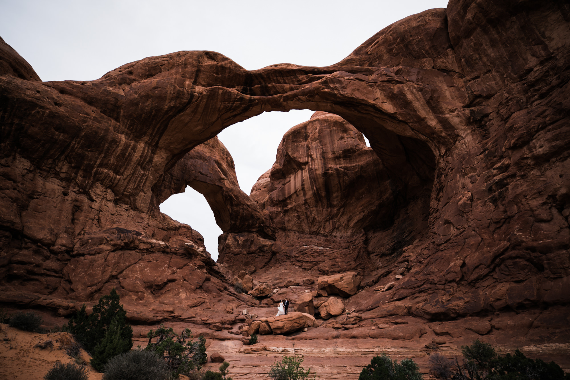 elopement first look in arches national park | desert elopement | moab wedding photographer | the hearnes adventure photography | www.thehearnes.com