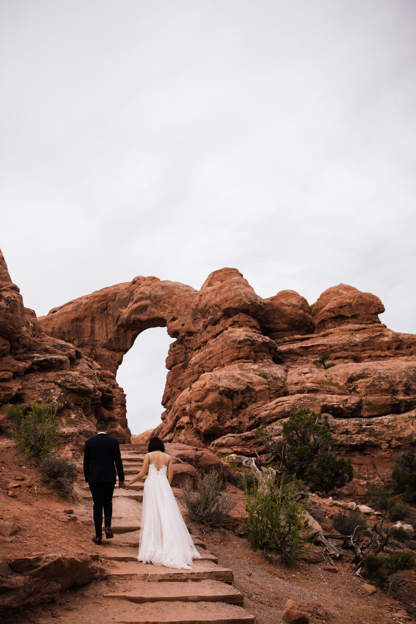 elopement first look in arches national park | desert elopement | moab wedding photographer | the hearnes adventure photography | www.thehearnes.com