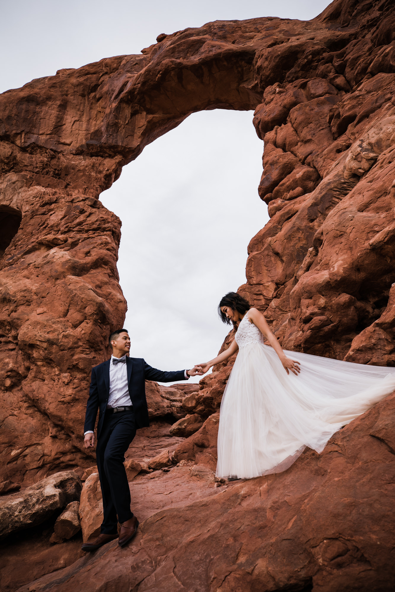 elopement first look in arches national park | desert elopement | moab wedding photographer | the hearnes adventure photography | www.thehearnes.com