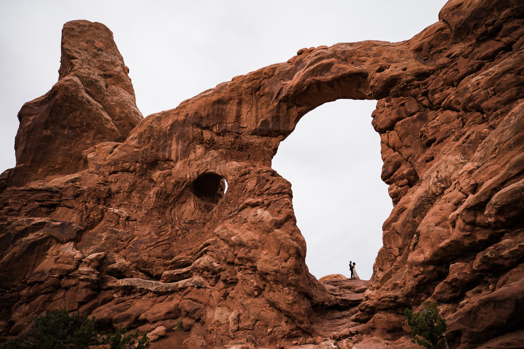 elopement first look in arches national park | desert elopement | moab wedding photographer | the hearnes adventure photography | www.thehearnes.com