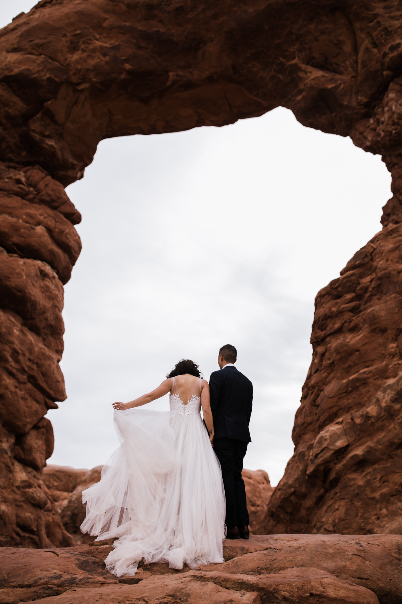 elopement first look in arches national park | desert elopement | moab wedding photographer | the hearnes adventure photography | www.thehearnes.com