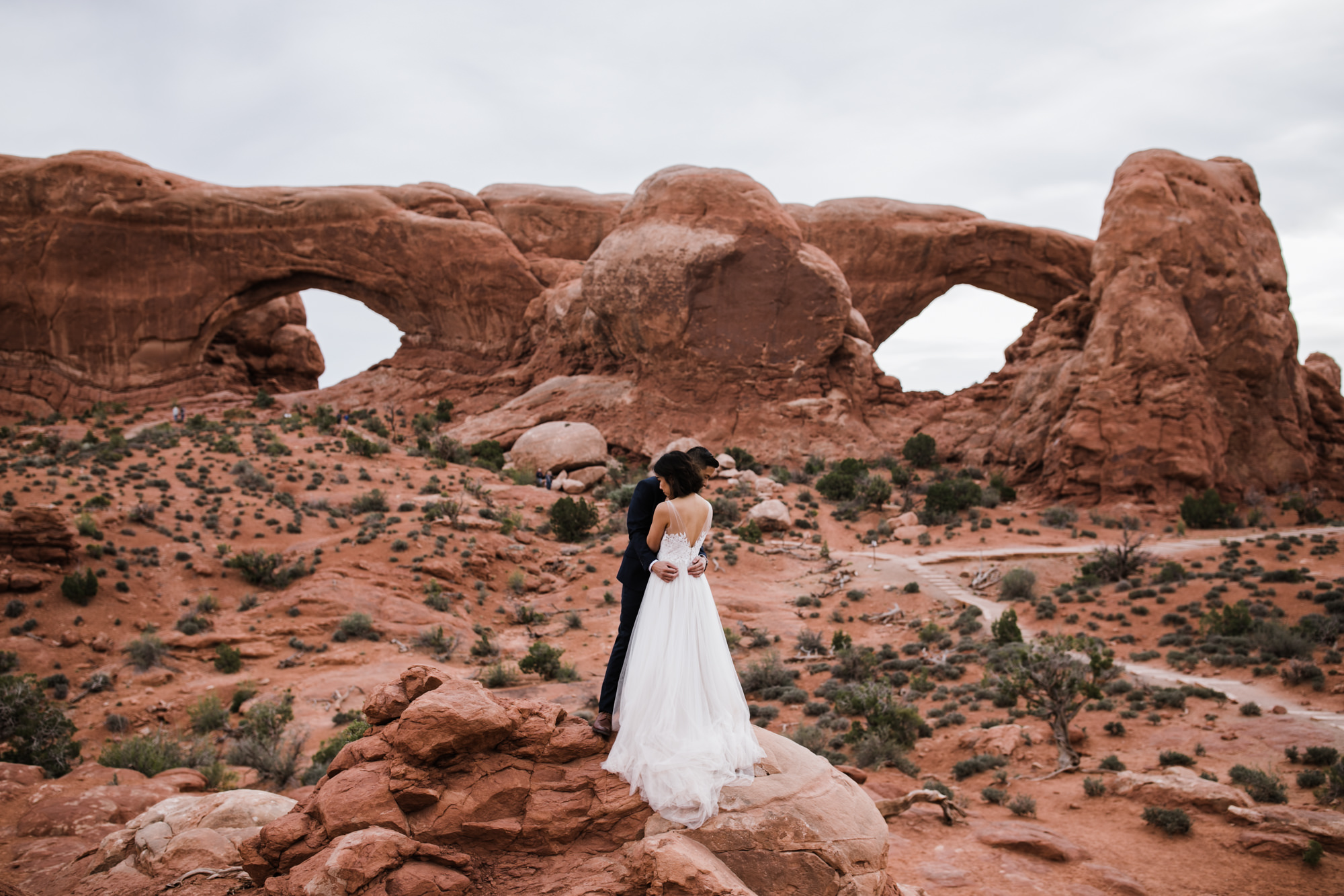 elopement first look in arches national park | desert elopement | moab wedding photographer | the hearnes adventure photography | www.thehearnes.com