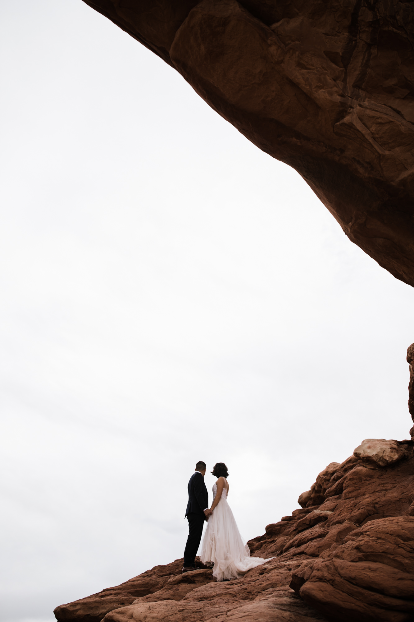 elopement first look in arches national park | desert elopement | moab wedding photographer | the hearnes adventure photography | www.thehearnes.com